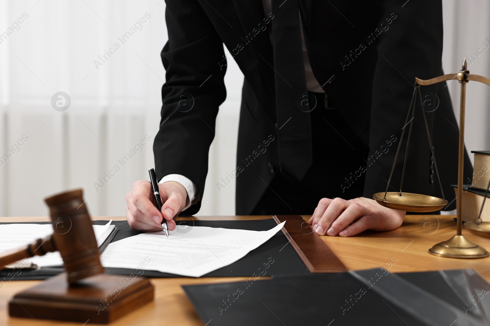 Photo of Lawyer working with document at wooden table, closeup