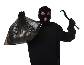 Emotional thief in balaclava with crowbar and bag raising hands on white background