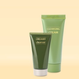 Tubes of creamy cleansers on beige background. Makeup remover 