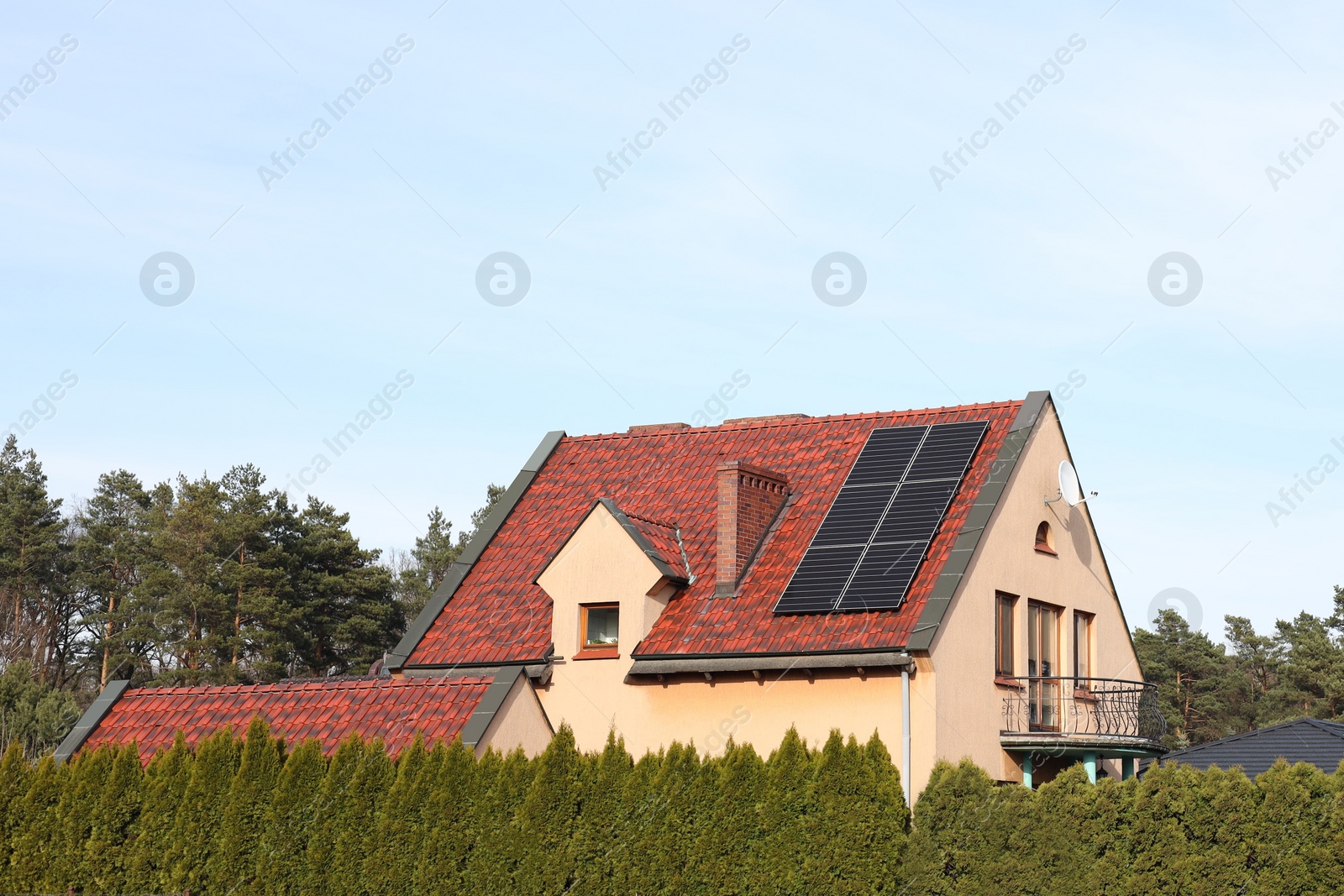 Photo of House with installed solar panels on roof. Alternative energy