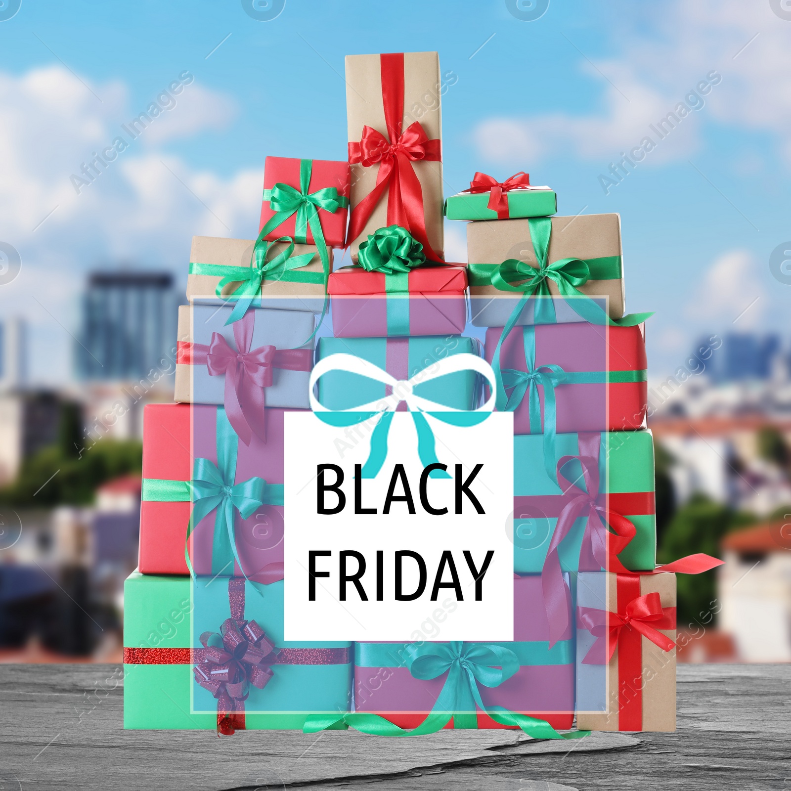 Image of Black Friday. Many gift boxes and blurred cityscape on background