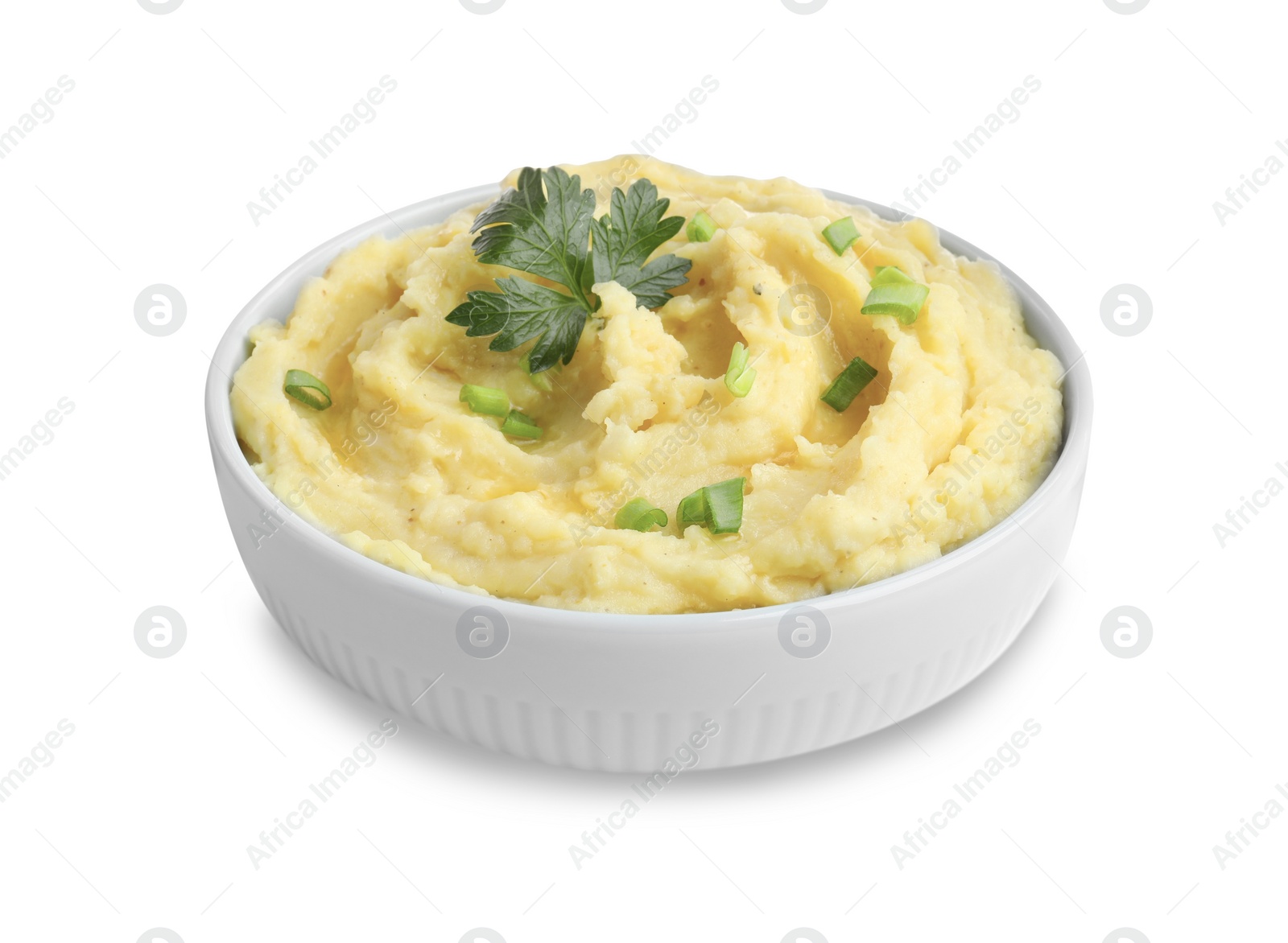 Photo of Bowl of tasty mashed potatoes with parsley and green onion isolated on white