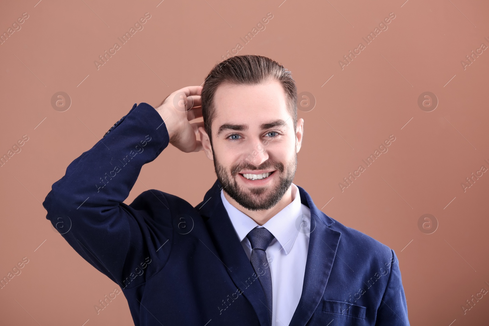 Photo of Portrait of young businessman with beautiful hair on color background