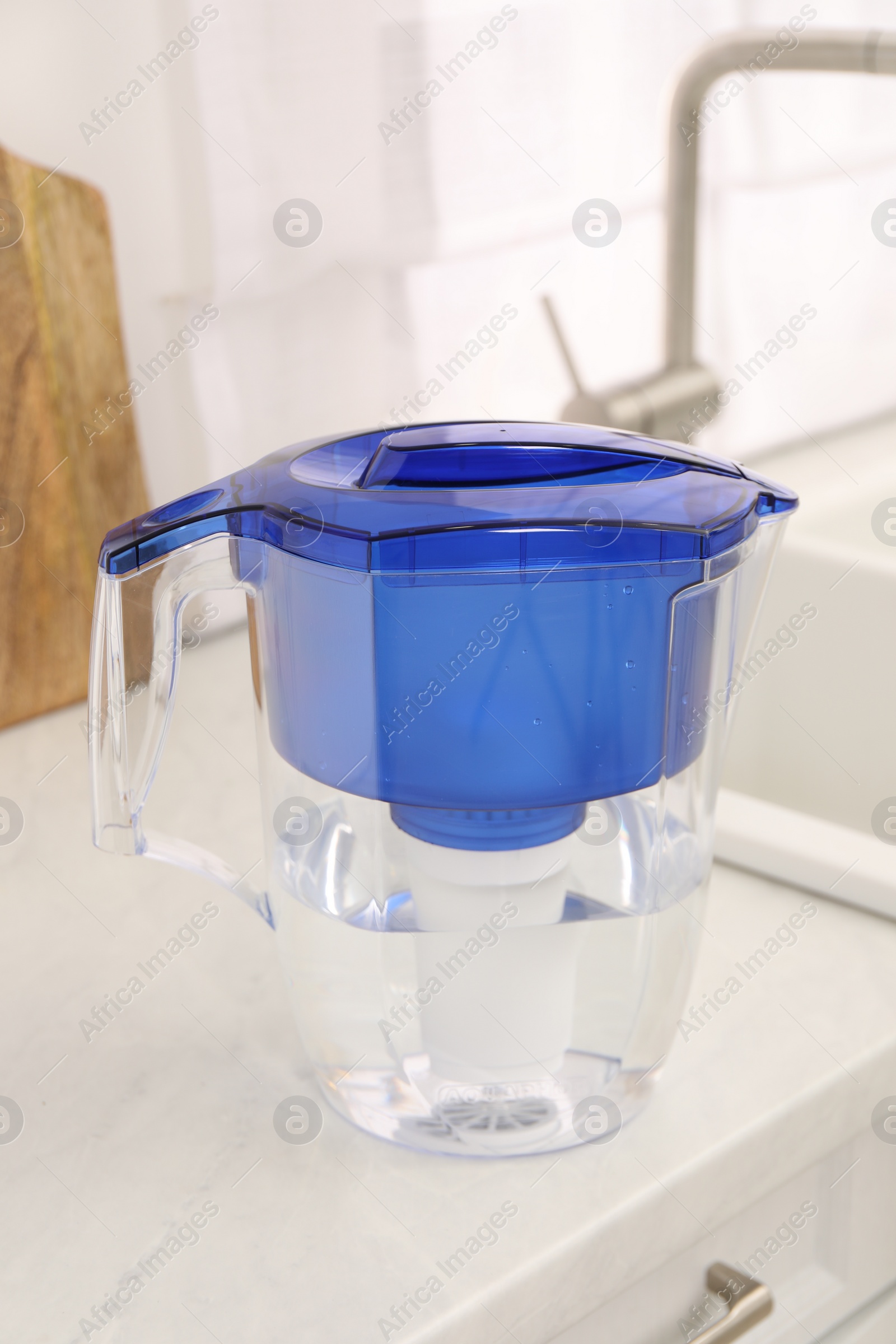 Photo of Water filter jug on white countertop in kitchen