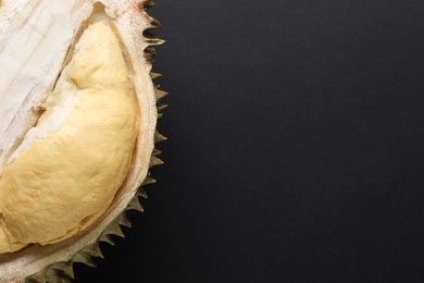 Fresh ripe durian on black background, top view. Space for text
