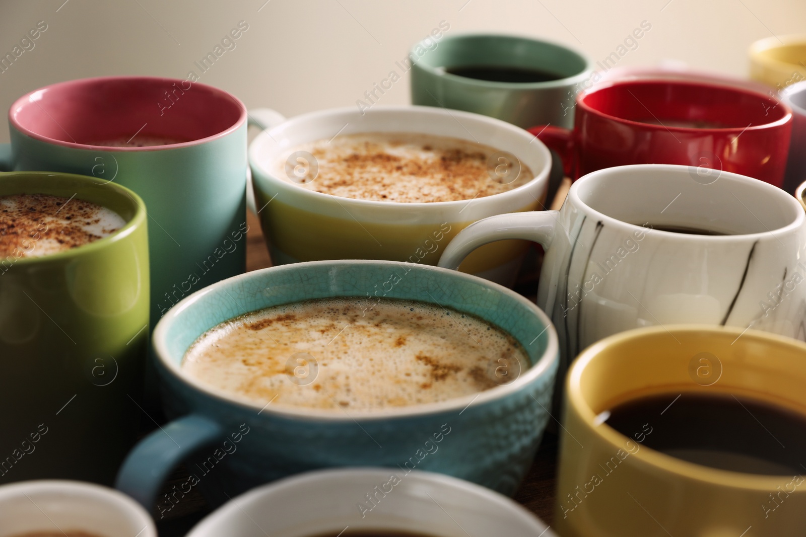 Photo of Many cups of different coffees on table, closeup