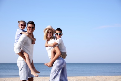 Photo of Happy family at beach on sunny day