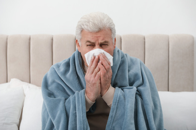 Photo of Mature suffering from cold at home. Dangerous virus