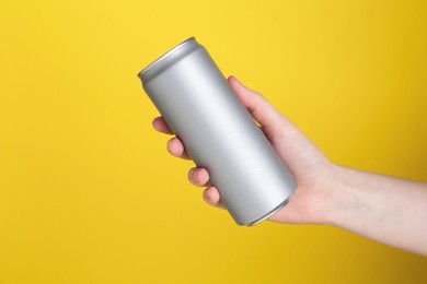 Photo of Woman with energy drink on yellow background, closeup