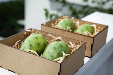 Delicious fresh ripe opuntia fruits in wooden box outdoors