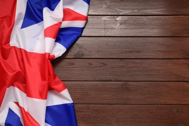 Flag of United Kingdom on wooden background, top view. Space for text
