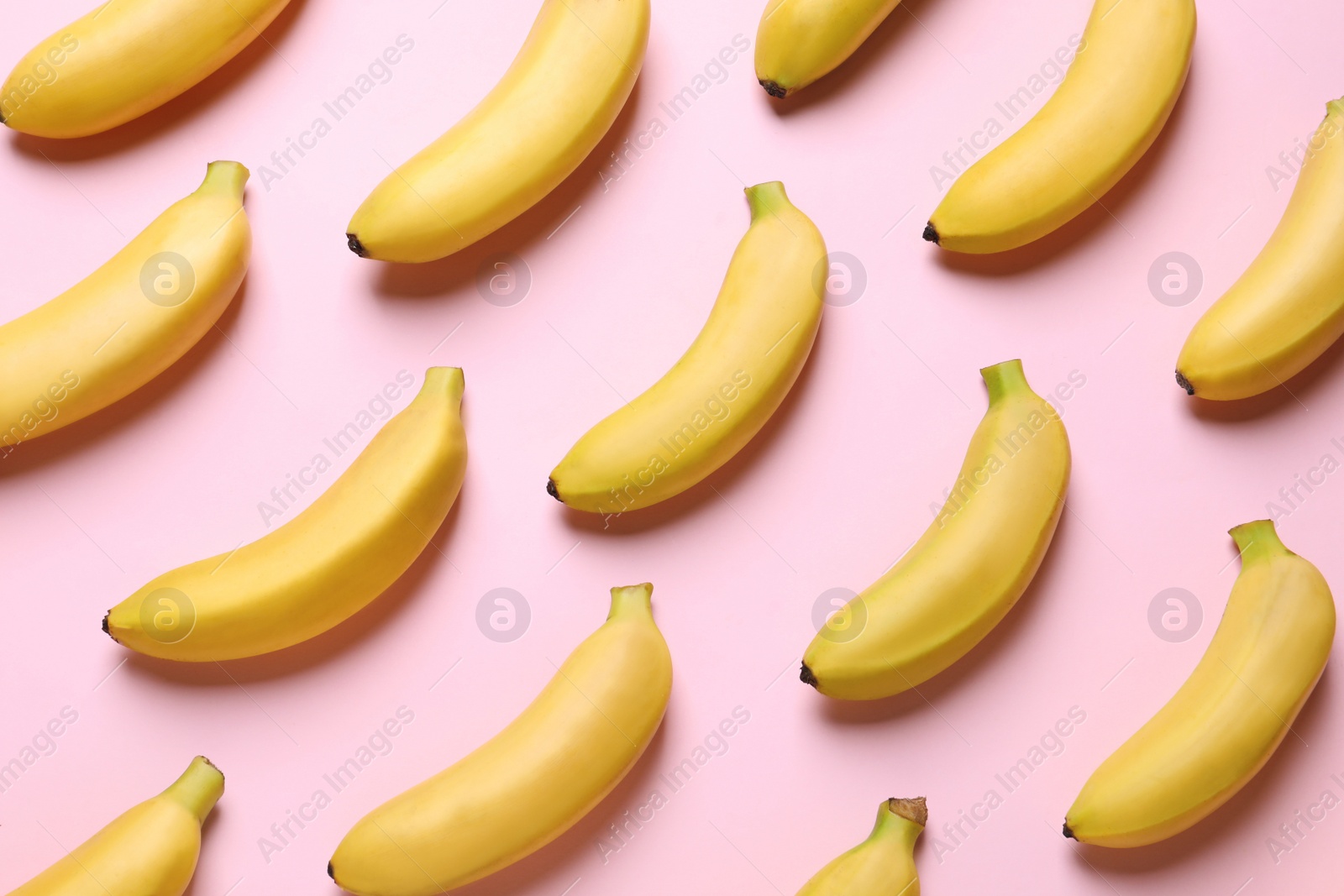 Photo of Sweet ripe baby bananas on light pink background, flat lay