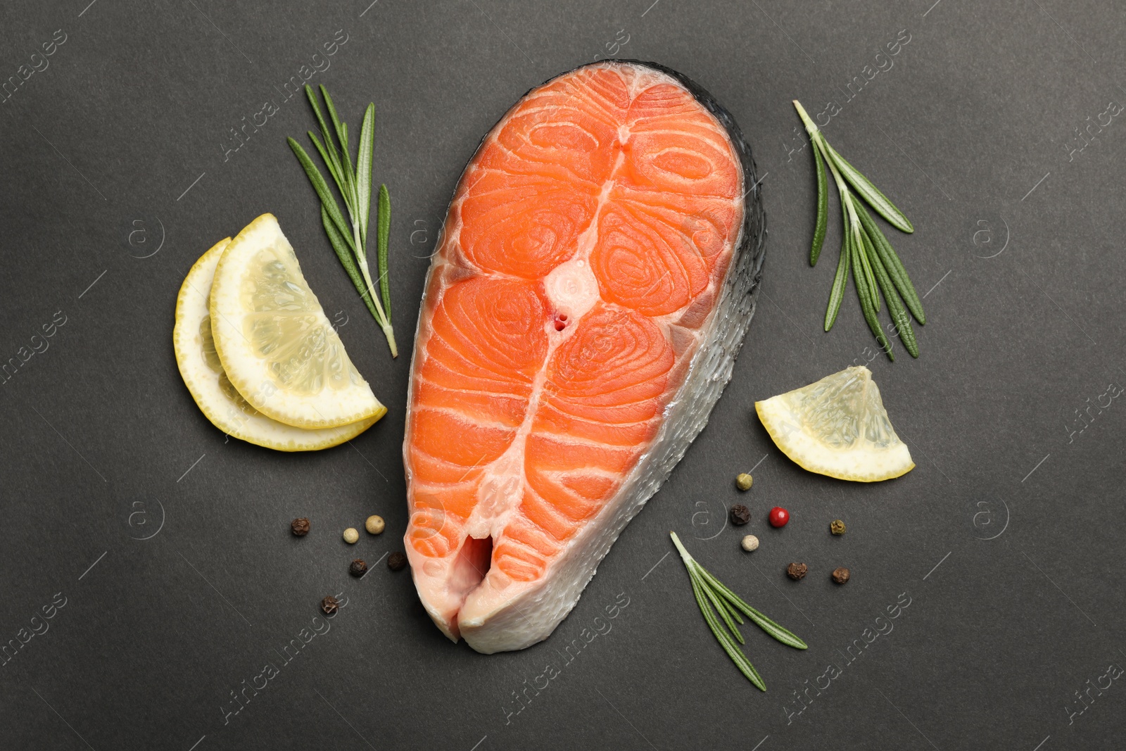 Photo of Flat lay composition with salmon steak on black background