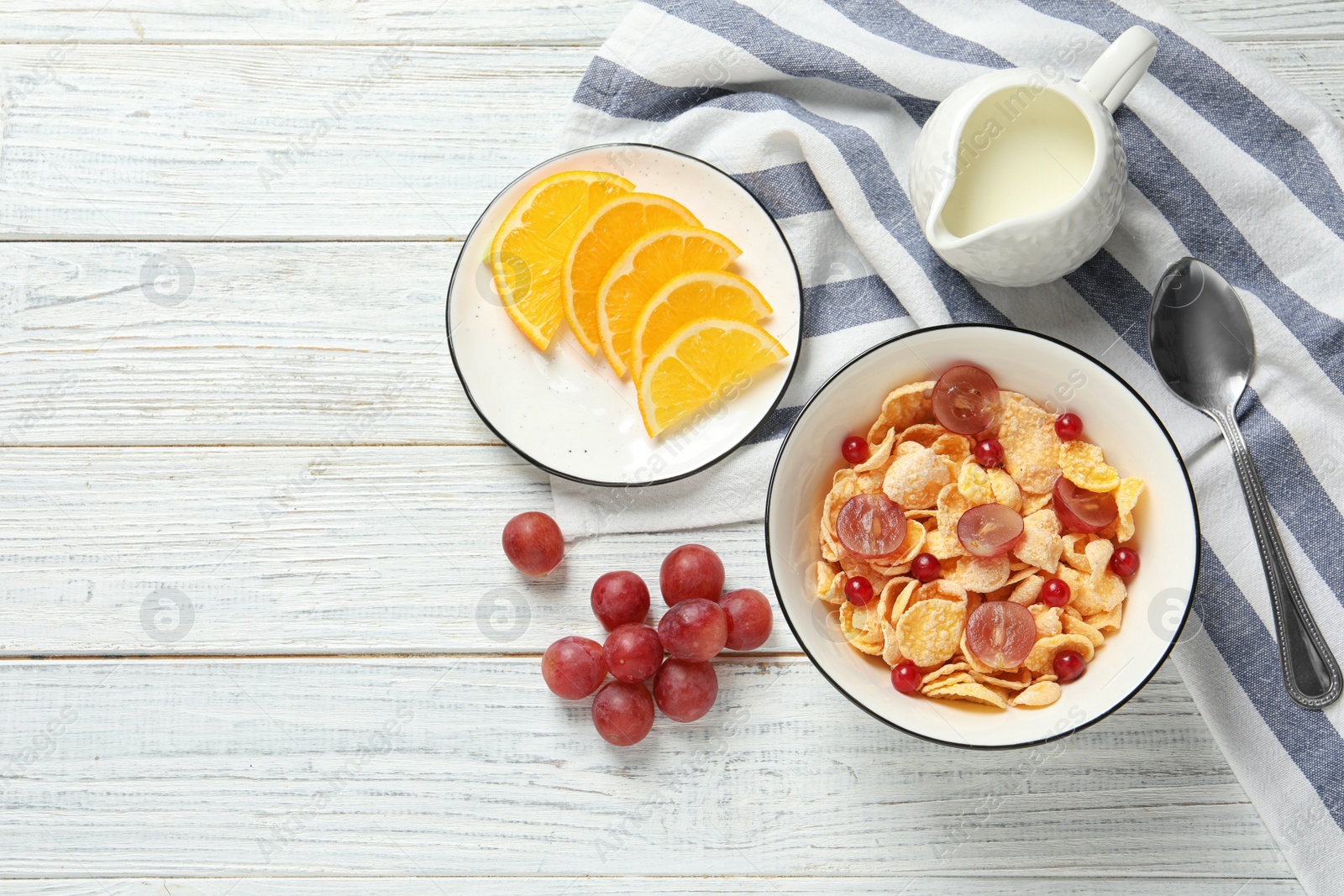 Photo of Tasty healthy breakfast served on white wooden table, flat lay