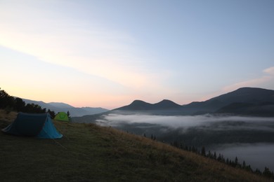 Photo of Picturesque view of camping tents in mountains