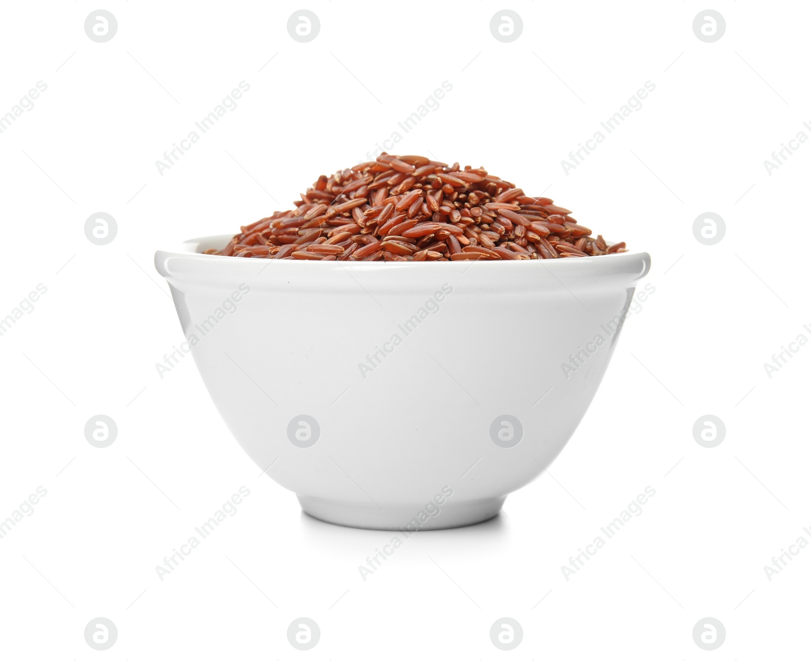 Photo of Bowl with uncooked red rice on white background