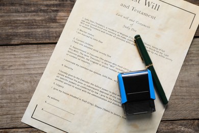 Photo of Last Will and Testament with fountain pen and stamp on wooden table, top view
