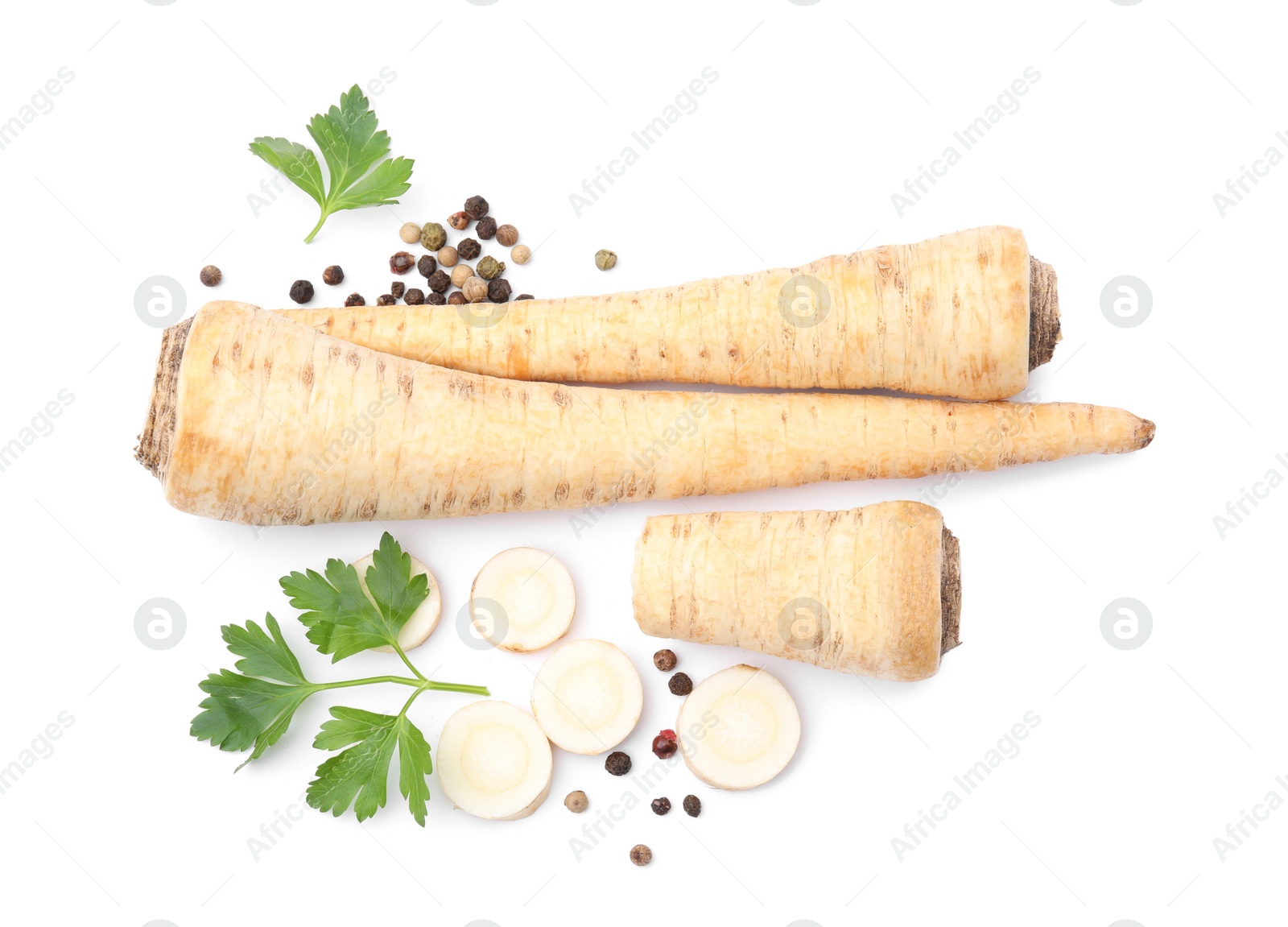 Photo of Whole and cut raw parsley roots, fresh herb isolated on white, top view