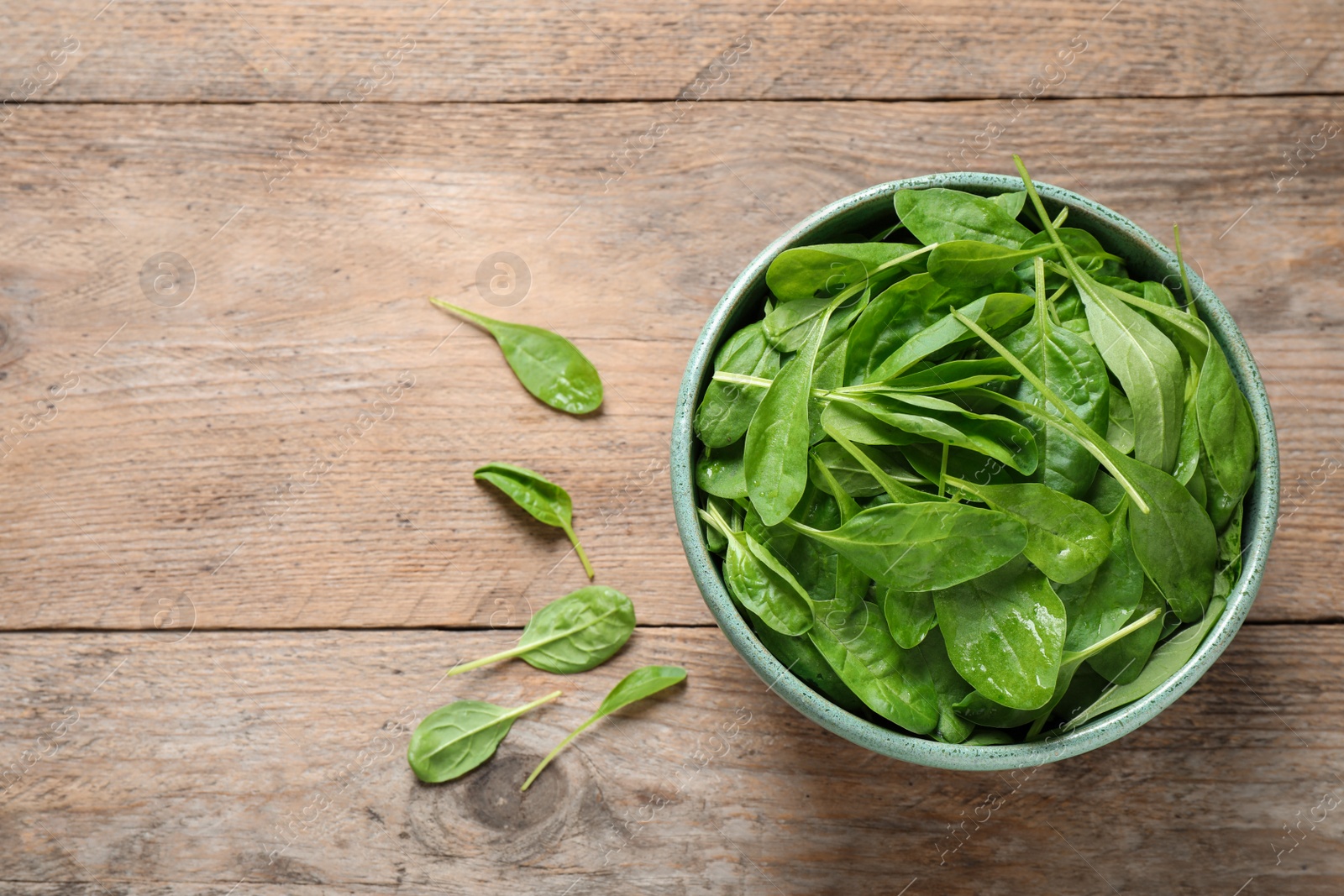 Photo of Fresh green healthy spinach on wooden table, flat lay. Space for text