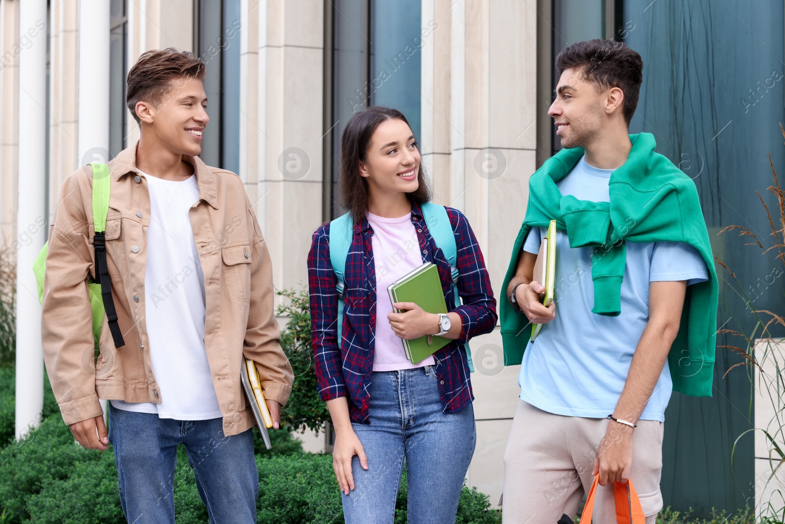 Photo of Happy young students spending time together outdoors