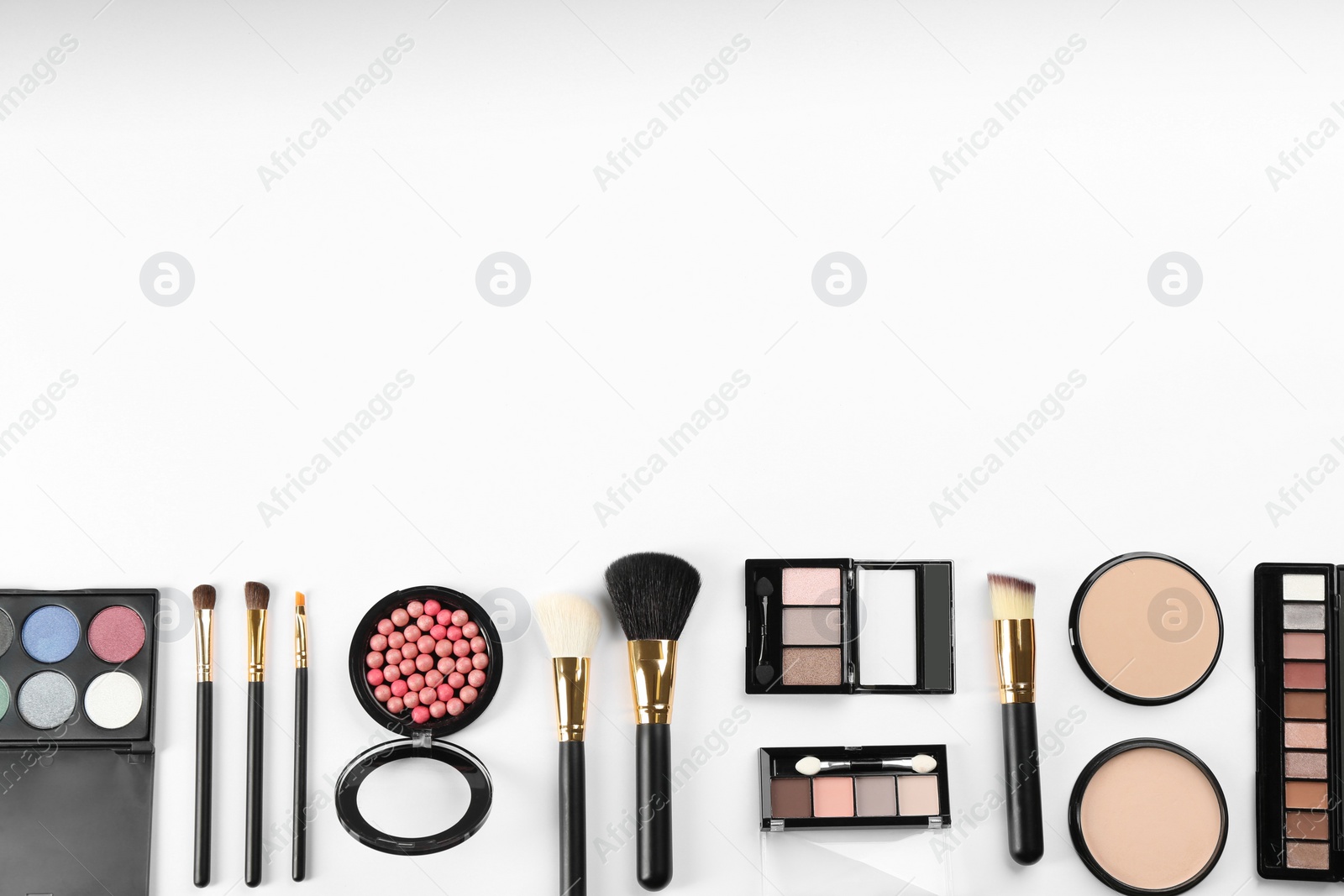 Photo of Flat lay composition with makeup brushes on white background, space for text