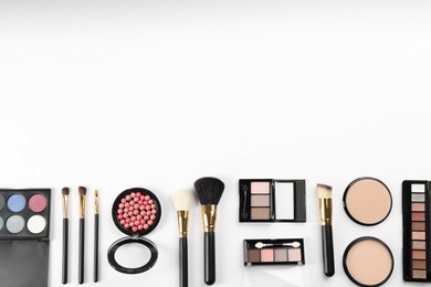 Photo of Flat lay composition with makeup brushes on white background, space for text