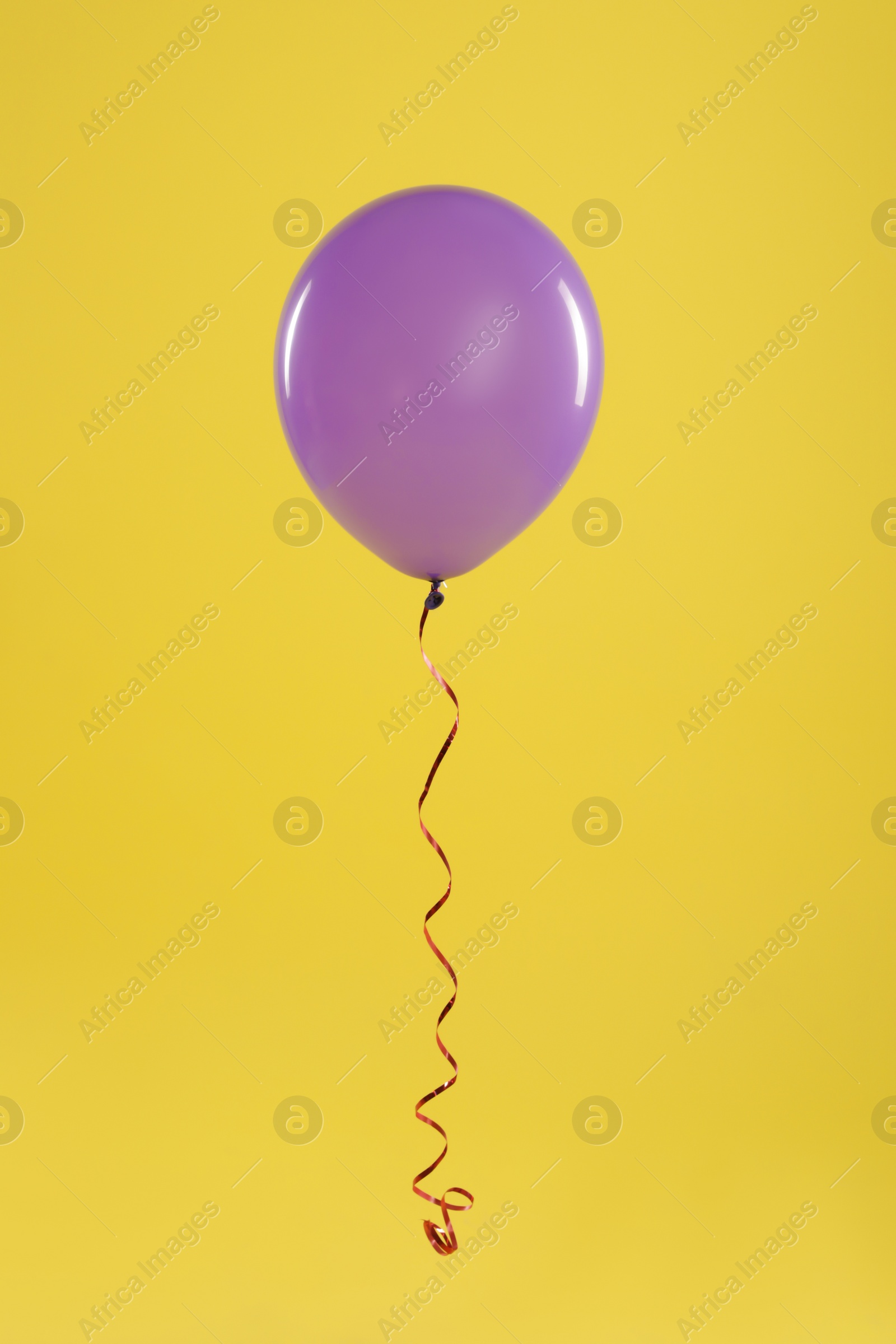 Photo of Bright balloon on color background. Celebration time