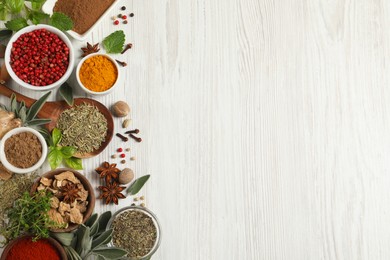 Photo of Different fresh herbs and spices on white wooden table, flat lay. Space for text