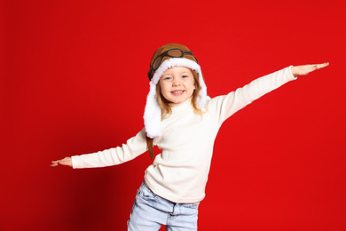 Photo of Portrait of cute little girl on red background