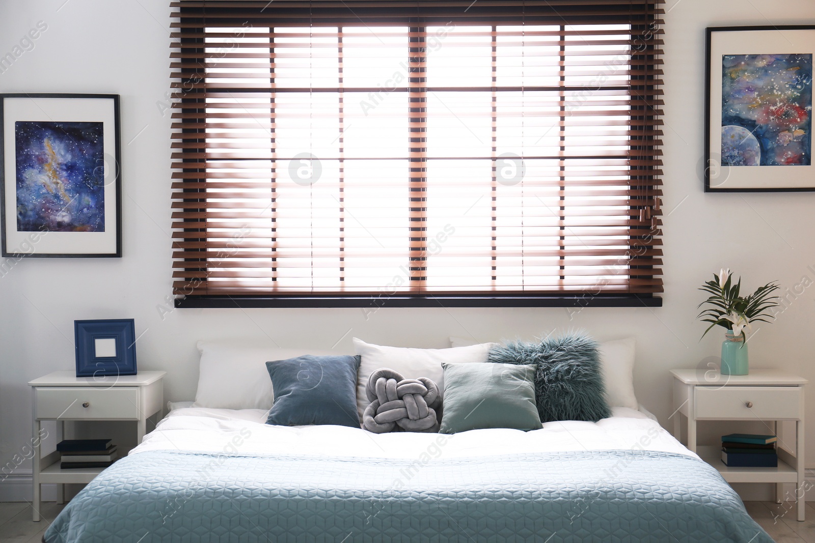 Photo of Modern room interior with comfortable double bed and window blinds