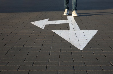 Photo of Man going along road with arrows marking, closeup