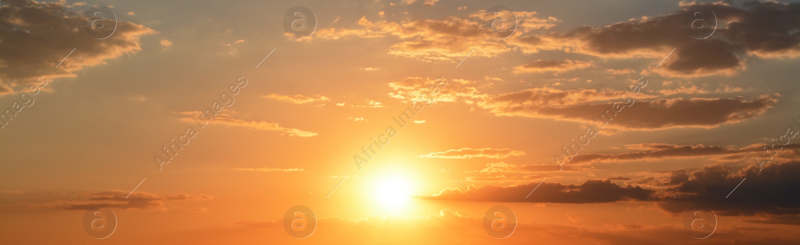 Image of Sun shining on beautiful cloudy sky at sunset, banner design