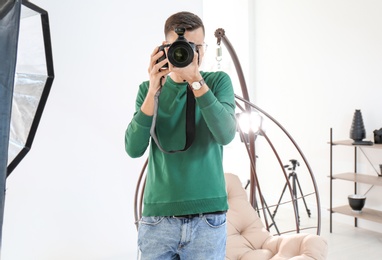 Photo of Young photographer working in professional studio