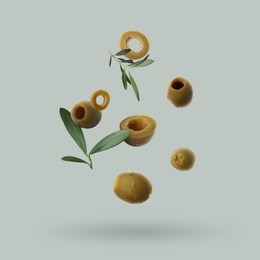 Image of Fresh olives and leaves falling on light grey background