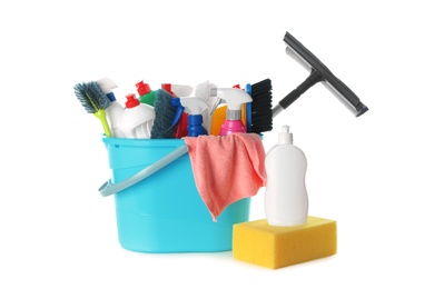 Plastic bucket with different cleaning supplies on white background