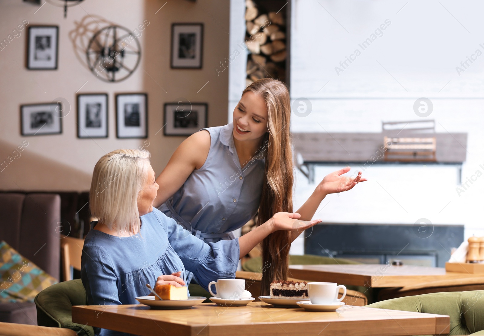 Photo of Mother and her adult daughter spending time together in cafe