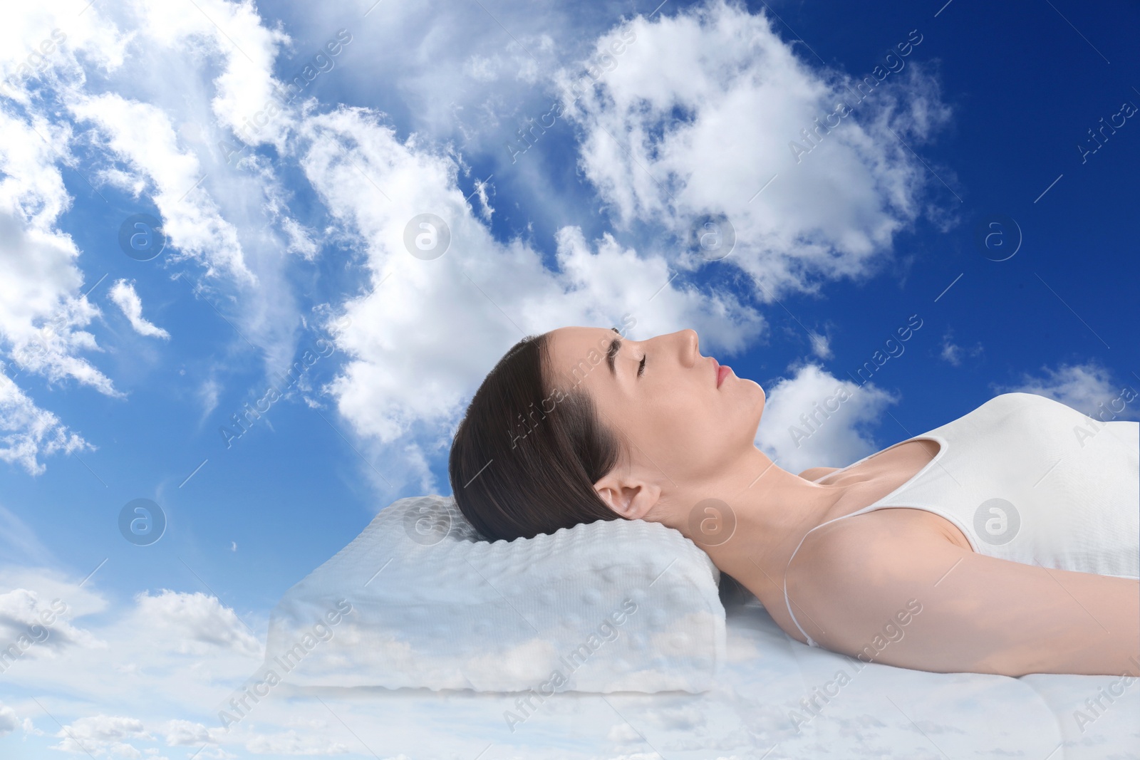 Image of Woman sleeping on orthopedic pillow against blue sky