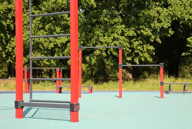 Photo of Empty outdoor gym with exercise equipment in park