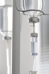 Photo of IV drip chamber against blurred light background