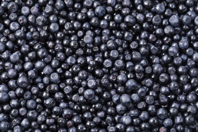 Photo of Many delicious ripe bilberries as background, top view