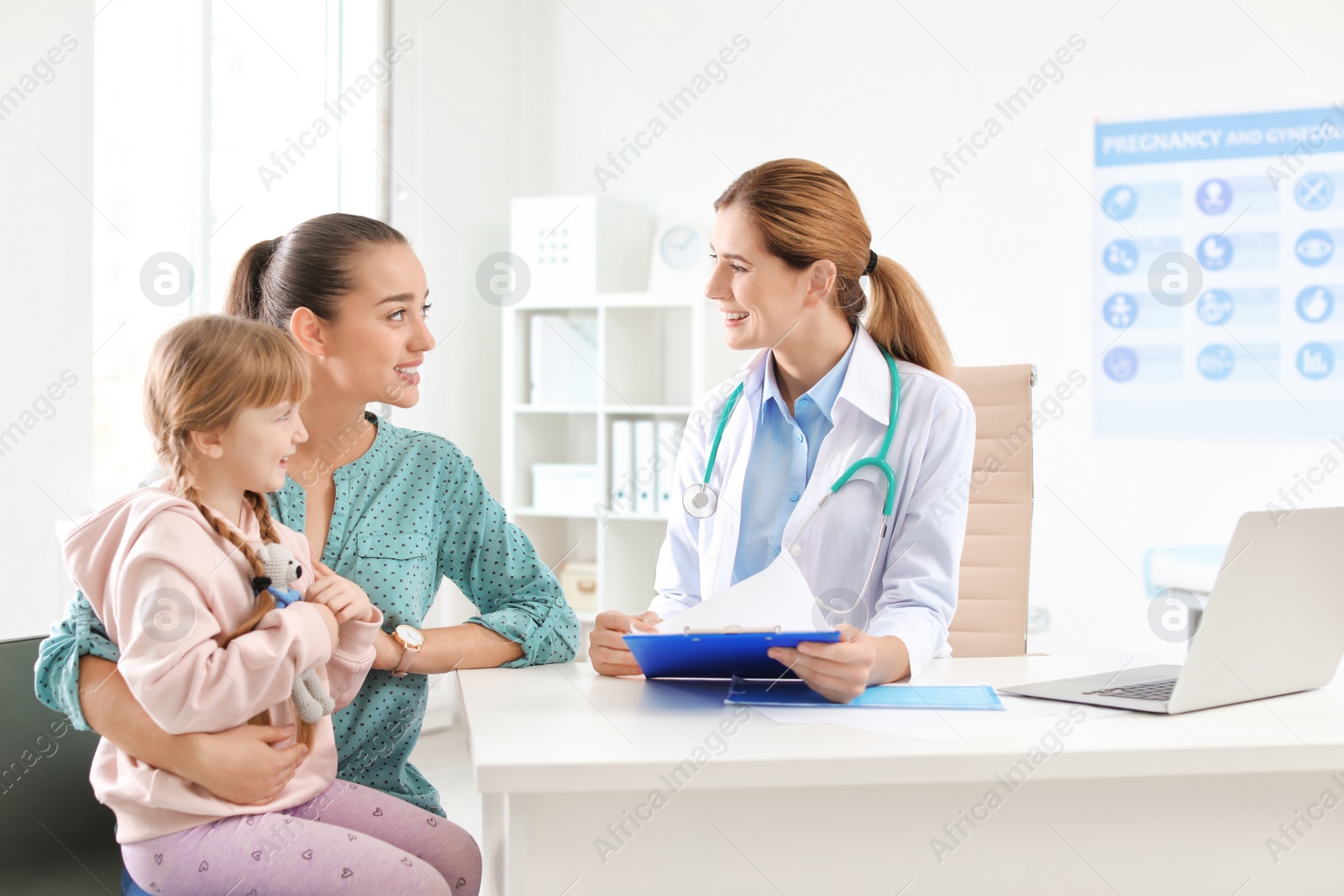 Photo of Little girl with parent visiting children's doctor in hospital