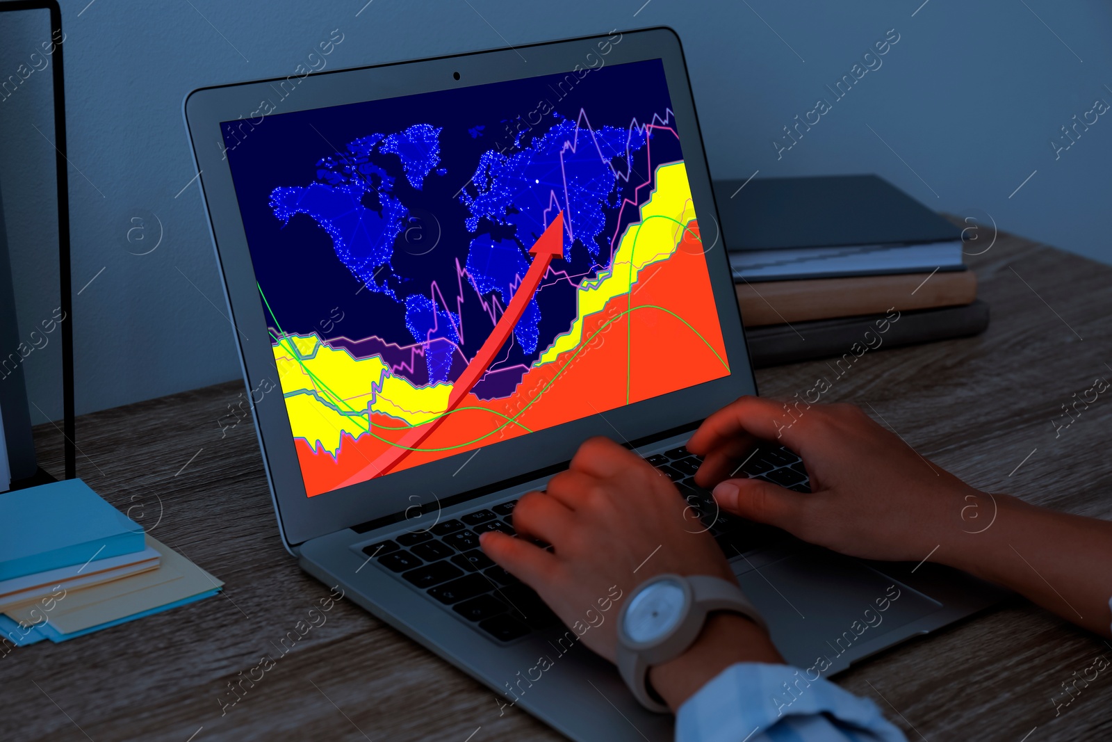 Image of Woman analyzing situation on international market via laptop, closeup. World map and charts on screen