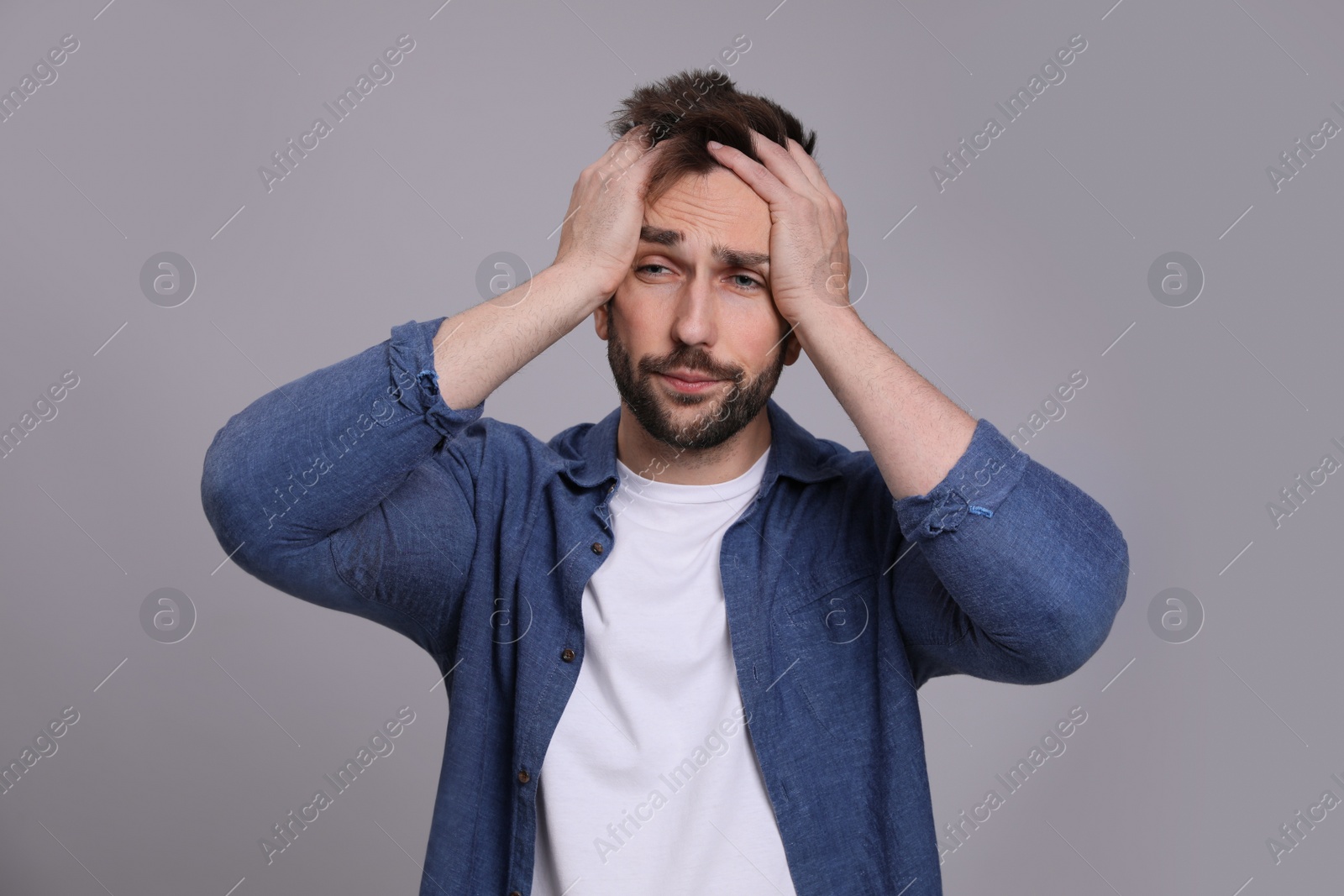 Photo of Man suffering from headache on grey background. Cold symptoms