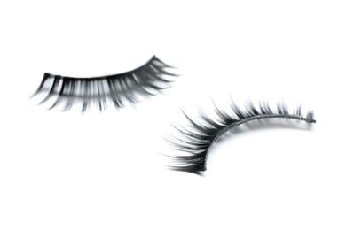 Beautiful pair of false eyelashes on white background