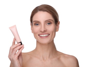 Woman holding tube with foundation on white background