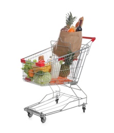 Photo of Shopping cart with groceries on white background