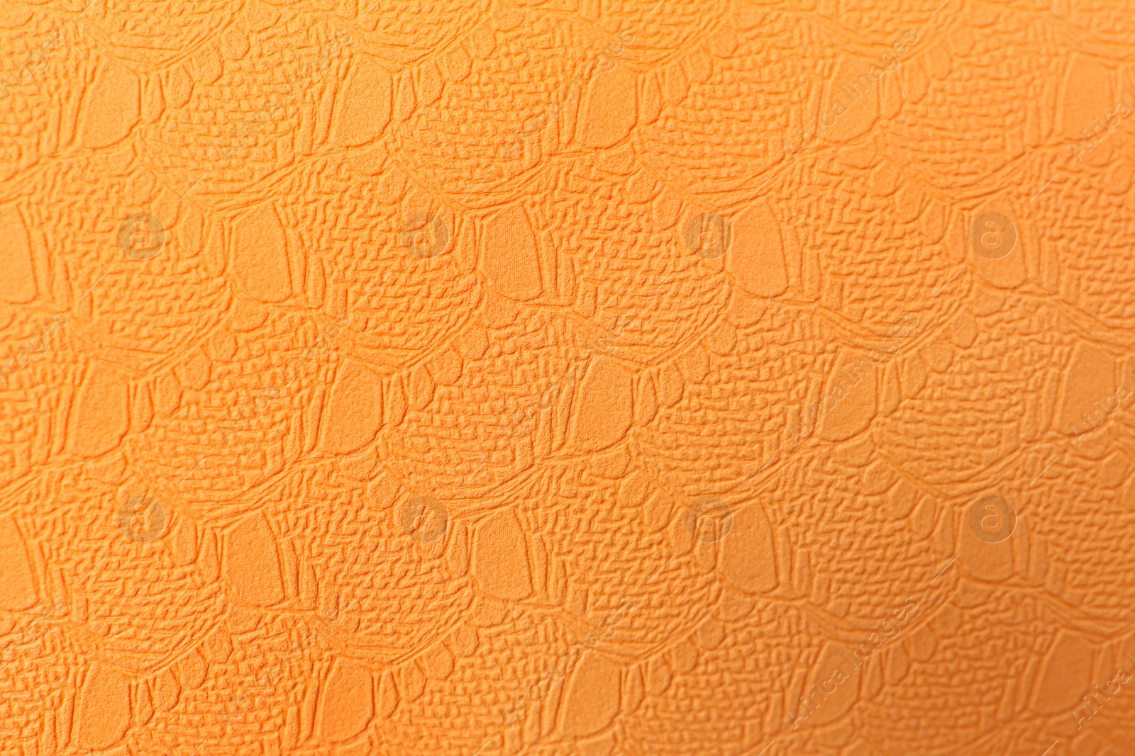Photo of Stylish orange wallpaper as background, top view
