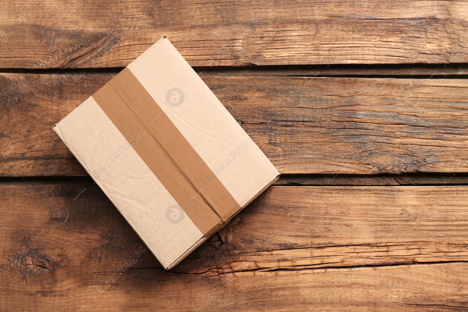 Photo of Cardboard box on wooden background