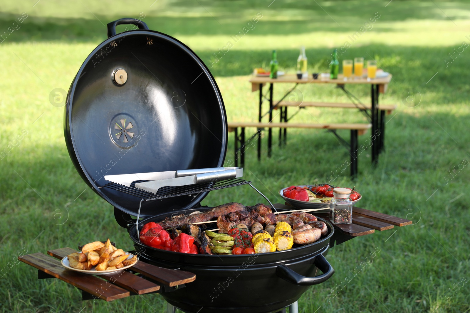 Photo of Tasty meat and vegetables on barbecue grill outdoors