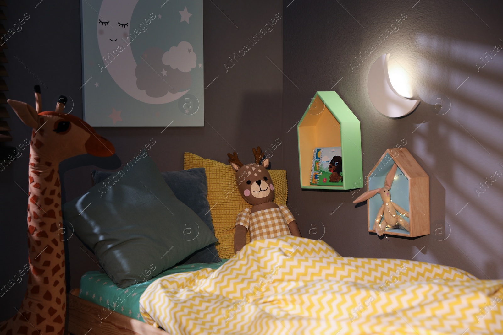 Photo of Crescent shaped night lamp on wall in child's room